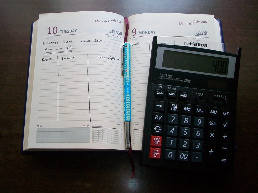 A handwritten budgeting and expense notebook for tracking monthly spending