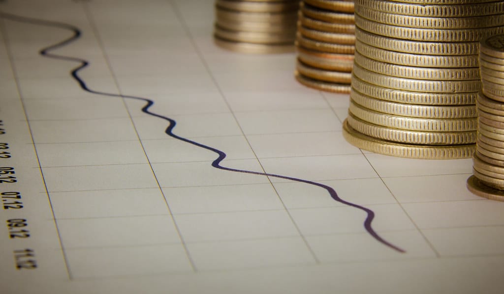 A finance growth chart with stacks of coins illustrating installment loan repayment over time